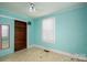 Cozy bedroom with neutral walls, a window with blinds, closet, and unique vintage-patterned flooring at 1070 Nc 182 Hwy, Lincolnton, NC 28092