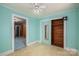 Bright bedroom featuring a sliding closet door, ceiling fan, and doorway entrance at 1070 Nc 182 Hwy, Lincolnton, NC 28092