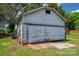 Exterior view of the garage in the backyard. The garage has white siding and a large garage door at 1070 Nc 182 Hwy, Lincolnton, NC 28092