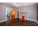 Open living room featuring a decorative fireplace, classic hard wood floors, and multiple doorways at 1070 Nc 182 Hwy, Lincolnton, NC 28092
