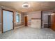 Open-concept living area with fireplace, natural light, multiple doorways, and classic tiled flooring at 1070 Nc 182 Hwy, Lincolnton, NC 28092