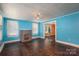 Bright living room with hard wood floors, natural light from two windows, and a decorative fireplace at 1070 Nc 182 Hwy, Lincolnton, NC 28092