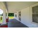 Inviting covered front porch with classic support columns, a view of the yard, and paneled ceiling at 1070 Nc 182 Hwy, Lincolnton, NC 28092