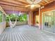 Large screened-in porch with rustic ceiling and a comfortable hammock swing at 10710 Bristlecone Ct, Mint Hill, NC 28227