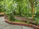 Secluded backyard featuring lush greenery and brick landscaping accents at 10710 Bristlecone Ct, Mint Hill, NC 28227