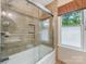 Bathroom with a tiled shower and glass door plus a window for lots of natural light at 10710 Bristlecone Ct, Mint Hill, NC 28227
