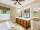 Spacious Primary bathroom with double sinks, a soaking tub, and natural light at 10710 Bristlecone Ct, Mint Hill, NC 28227