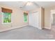 Bedroom featuring carpet floors, light paint and a large window with outside views at 10710 Bristlecone Ct, Mint Hill, NC 28227
