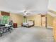 Large bedroom with carpet flooring, neutral paint, large windows, and ceiling fan at 10710 Bristlecone Ct, Mint Hill, NC 28227