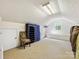 Bonus room featuring sloped ceilings, a window, carpeting and a storage cabinet at 10710 Bristlecone Ct, Mint Hill, NC 28227