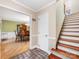 Open foyer with hardwood floors, decorative tile, and a staircase leading to the upper level at 10710 Bristlecone Ct, Mint Hill, NC 28227