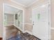 Bright foyer with hardwood floors, decorative tile, and views into the adjoining living spaces at 10710 Bristlecone Ct, Mint Hill, NC 28227