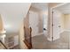 Hallway and staircase with carpet flooring, neutral paint and white doors and trim at 10710 Bristlecone Ct, Mint Hill, NC 28227