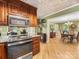 Updated kitchen with stainless steel appliances, granite countertops, and wooden cabinets at 10710 Bristlecone Ct, Mint Hill, NC 28227