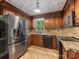 Updated kitchen with stainless steel appliances, granite countertops, and wooden cabinets at 10710 Bristlecone Ct, Mint Hill, NC 28227