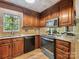 Updated kitchen with stainless steel appliances, granite countertops, and wooden cabinets at 10710 Bristlecone Ct, Mint Hill, NC 28227
