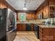 Updated kitchen with stainless steel appliances, granite countertops, and wooden cabinets at 10710 Bristlecone Ct, Mint Hill, NC 28227