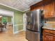 Charming kitchen with a stainless steel refrigerator and view into dining area at 10710 Bristlecone Ct, Mint Hill, NC 28227