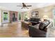 Comfortable living room featuring hardwood floors, a brick fireplace, and ample natural light at 10710 Bristlecone Ct, Mint Hill, NC 28227
