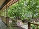 Inviting porch view of a landscaped backyard with mature trees and a charming water feature at 10710 Bristlecone Ct, Mint Hill, NC 28227