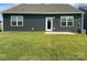 Nice backyard view with well-maintained lawn, door, windows, and modern dark siding at 108 Red Juniper Way, Statesville, NC 28625