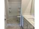 Bright bathroom features a white vanity, a tub-shower combo, and ceramic tile flooring at 108 Red Juniper Way, Statesville, NC 28625