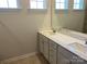 Bathroom featuring double sinks with sleek vanity and a large mirror for added convenience at 108 Red Juniper Way, Statesville, NC 28625