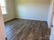 A sunlit bedroom showcases stylish wood-look floors and a neutral color palette at 108 Red Juniper Way, Statesville, NC 28625