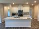 Spacious kitchen featuring white cabinets, stainless steel appliances, and a center island with quartz countertops at 108 Red Juniper Way, Statesville, NC 28625