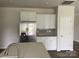 Bright kitchen featuring stainless steel refrigerator, white cabinets, and gray subway tile backsplash at 108 Red Juniper Way, Statesville, NC 28625