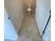 Compact water closet featuring tile flooring and fresh paint, maximizing space and functionality at 108 Red Juniper Way, Statesville, NC 28625