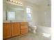 Bathroom featuring a bath tub, toilet, vanity, mirror, and natural light at 1083 Elljoy Ln, Salisbury, NC 28146