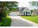 Charming single-Gathering home featuring a manicured lawn, long driveway, and attached two-car garage at 1083 Elljoy Ln, Salisbury, NC 28146