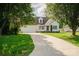 Charming single-Gathering home featuring a manicured lawn, long driveway, and attached two-car garage at 1083 Elljoy Ln, Salisbury, NC 28146