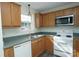 Functional kitchen featuring ample wood cabinetry, a stainless steel microwave, and modern flooring at 1083 Elljoy Ln, Salisbury, NC 28146