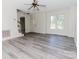 Bright and airy living room features new gray flooring, a front window and a staircase at 1083 Elljoy Ln, Salisbury, NC 28146