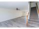 Bright living room with modern gray laminate flooring and a staircase leading to the upper level at 1083 Elljoy Ln, Salisbury, NC 28146