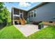 Backyard featuring brick patio, manicured lawn, and a charming screened porch at 10903 Skymont Dr, Huntersville, NC 28078