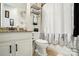 Cozy bathroom with white vanity, granite countertop, and decorative shower curtain at 10903 Skymont Dr, Huntersville, NC 28078
