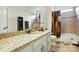 Bright bathroom featuring granite counters, a shower-tub combo, and neutral tiling at 10903 Skymont Dr, Huntersville, NC 28078