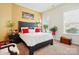 This is a main bedroom with a large bed, two windows, neutral colored carpet, and nice decor at 10903 Skymont Dr, Huntersville, NC 28078
