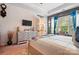 Main bedroom features a plush bed, ceiling fan, natural light, ensuite bath, and decorative wall art at 10903 Skymont Dr, Huntersville, NC 28078