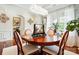 Bright dining room featuring a round table, chandelier, and large windows at 10903 Skymont Dr, Huntersville, NC 28078