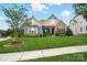 Well-maintained home with lush green lawn, mature landscaping, and partial tree coverage at 10903 Skymont Dr, Huntersville, NC 28078