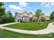 Gorgeous blue, stone, and beige home featuring a beautiful lawn, two car garage and landscaping at 10903 Skymont Dr, Huntersville, NC 28078