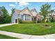 Lovely blue home features an attached two car garage, manicured lawn and beautiful landscaping at 10903 Skymont Dr, Huntersville, NC 28078