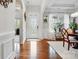 Elegant foyer with hardwood floors, a decorative front door, and adjacent dining area at 10903 Skymont Dr, Huntersville, NC 28078