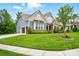 Lovely home with a well-kept lawn, a side-entry two-car garage, and a welcoming entrance at 10903 Skymont Dr, Huntersville, NC 28078