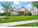Charming home with lush green lawn, mature trees, and a welcoming front facade at 10903 Skymont Dr, Huntersville, NC 28078