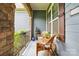 Cozy front porch with wicker seating and stone accents, perfect for relaxing at 10903 Skymont Dr, Huntersville, NC 28078